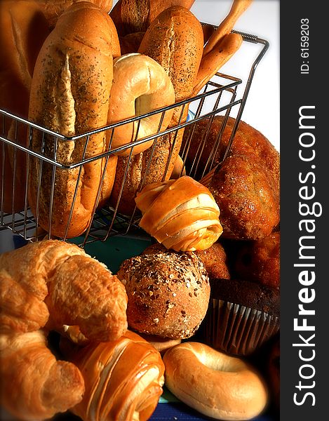 Small grocery cart with various breads inside. Small grocery cart with various breads inside