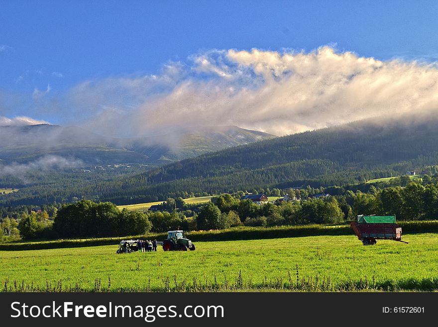 Harvesttime in Norway. Blue sky, white clouds and green grass makes it looking fresh. Harvesttime in Norway. Blue sky, white clouds and green grass makes it looking fresh.