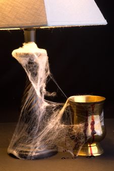 Light And Goblet In Cobwebs Royalty Free Stock Photography