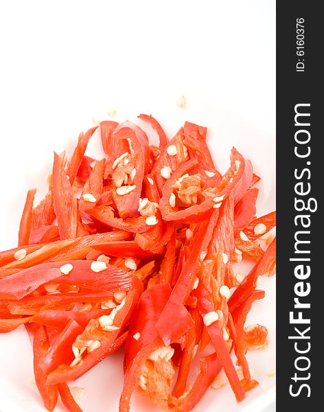 Fresh sliced chili in isolated white plate