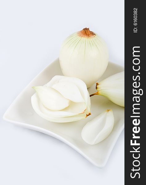 Sliced onion in white plate isolated on background