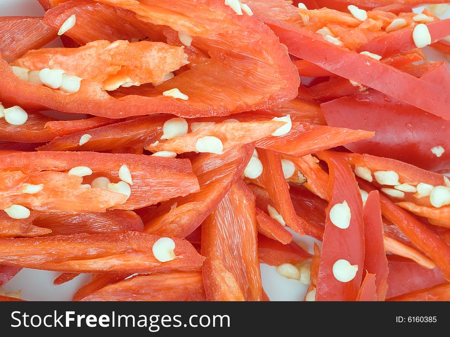 Fresh sliced chili in isolated white plate