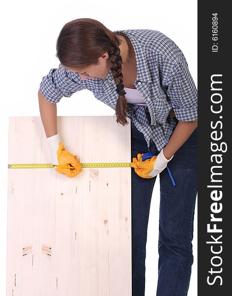 Woman carpenter with wooden plank and measuring tape