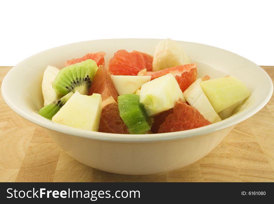 A fresh fruit salad with banana, apple, grapefruit and kiwi.