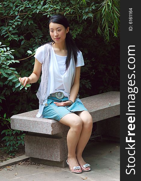 Chinese young girl sit alone