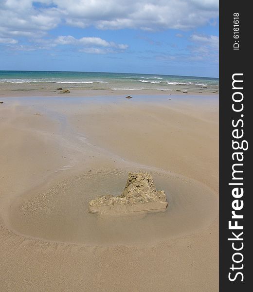 The ocean shape a stone on beach into a heart figure. The ocean shape a stone on beach into a heart figure.