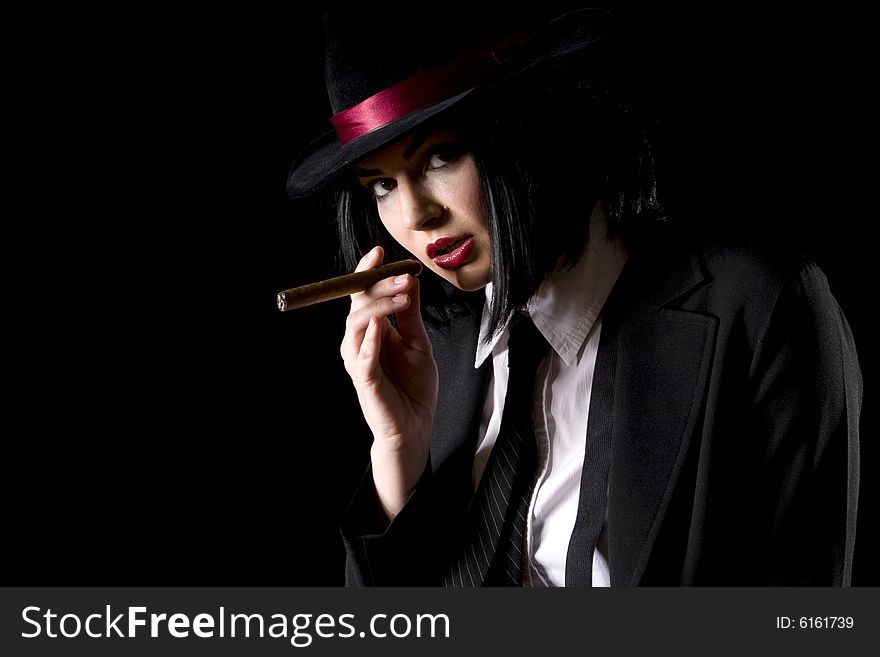 Attractive brunette dressed as a new york gangster with black background