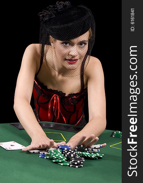 Attractive blond woman betting all her chips in a game of poker. Attractive blond woman betting all her chips in a game of poker