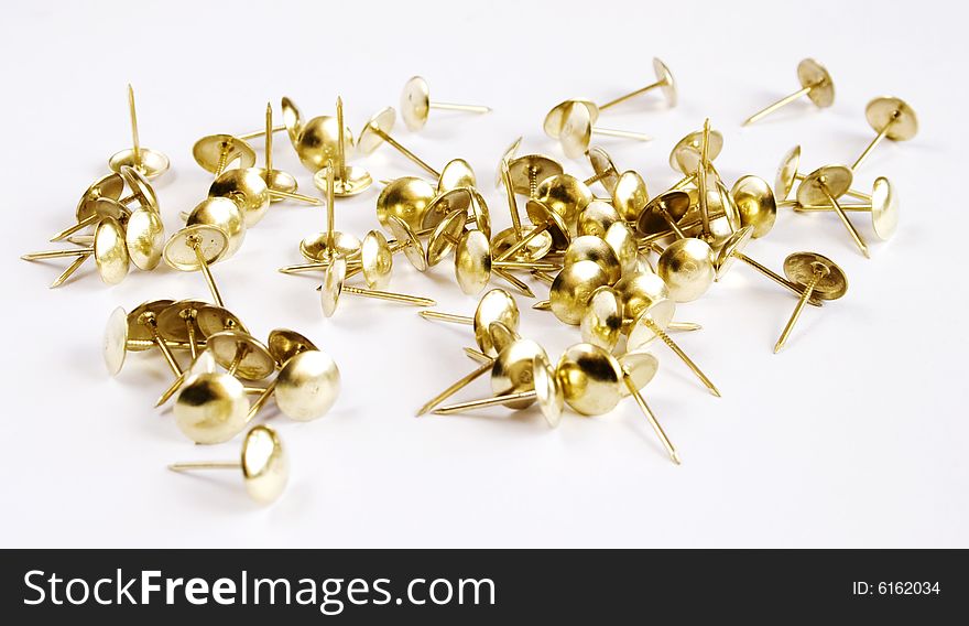 Nails on white background. Group of objects chaotically scattered on a table.