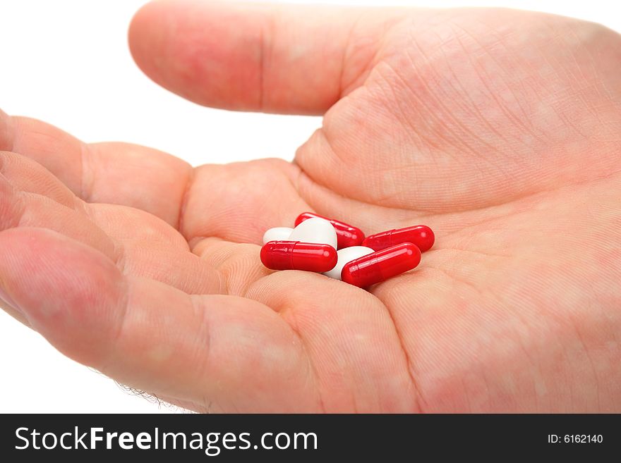 Male hand holding assorted pills and capsules. Male hand holding assorted pills and capsules
