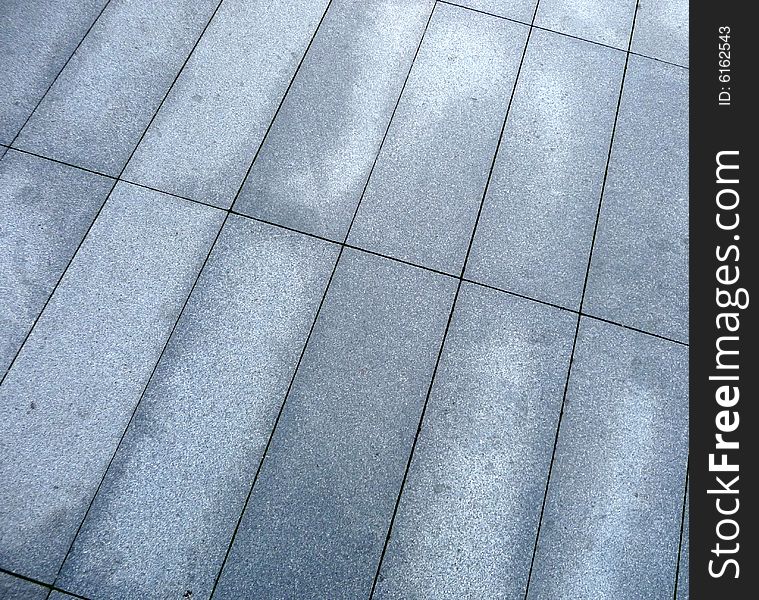 A photograph of some rectangle pavement slabs. A photograph of some rectangle pavement slabs.
