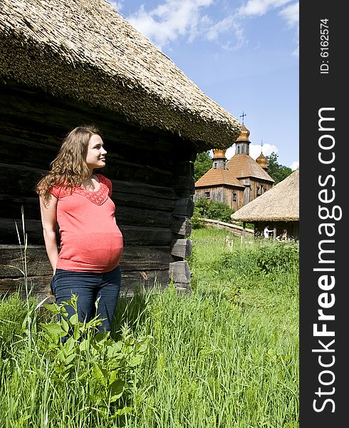 A pregnant woman looks at a church