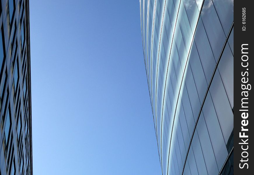 An abstract view of the glass windows of a modern building. An abstract view of the glass windows of a modern building.