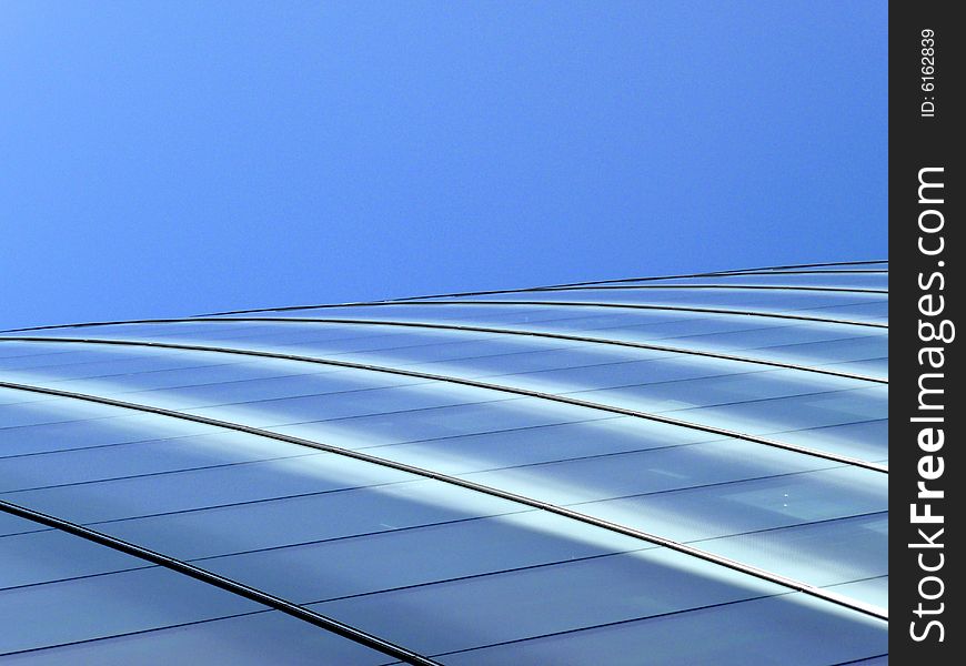 An abstract view of the glass windows of a modern building. An abstract view of the glass windows of a modern building.