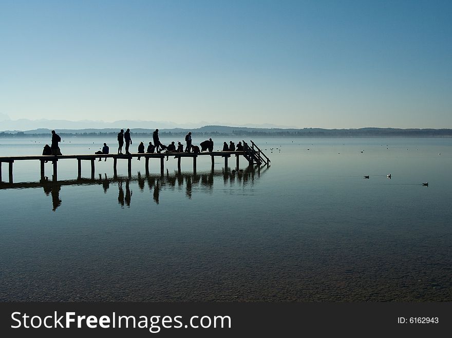 People on a footbridge (morning, Starnberger lake, Bavaria, Germany)