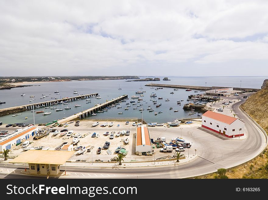 Port facility full of boats under cloudscape