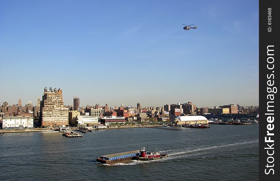 Busy traffic on a water and in the air in Manhattan, New York City. Busy traffic on a water and in the air in Manhattan, New York City.