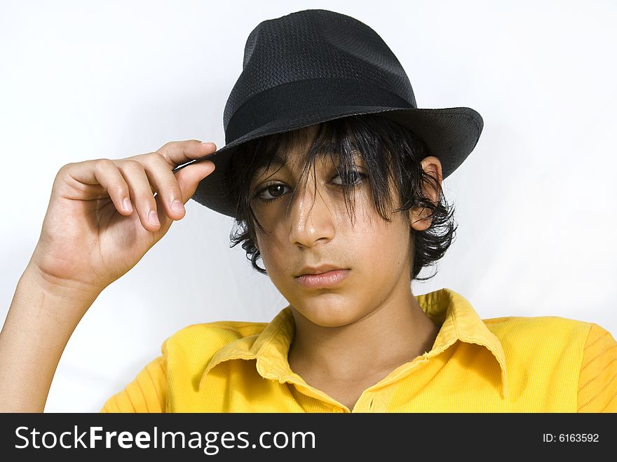 Teenager with black hat isolated on white background. Teenager with black hat isolated on white background