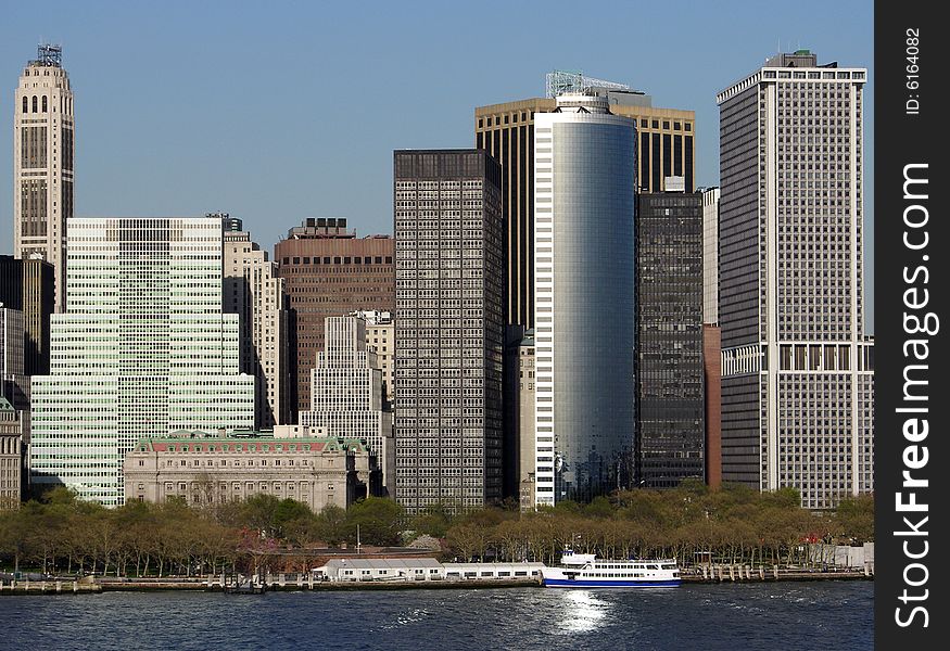 Different style skyscraper filled with evening sunlight in lower Manhattan, New York City. Different style skyscraper filled with evening sunlight in lower Manhattan, New York City.