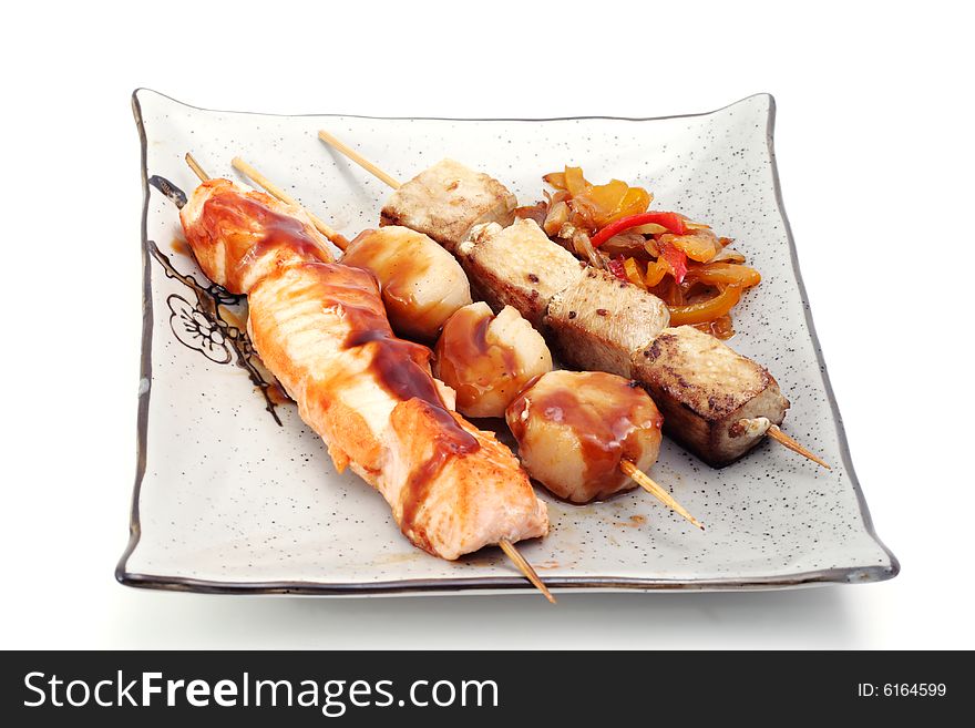 Japan Shish Kebab from Tuna Fish, Salmon and Scallop with Vegetables. Isolated on White Background. Japan Shish Kebab from Tuna Fish, Salmon and Scallop with Vegetables. Isolated on White Background