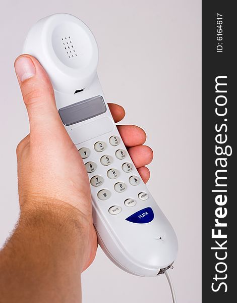 An image of telephone in mans hand. An image of telephone in mans hand