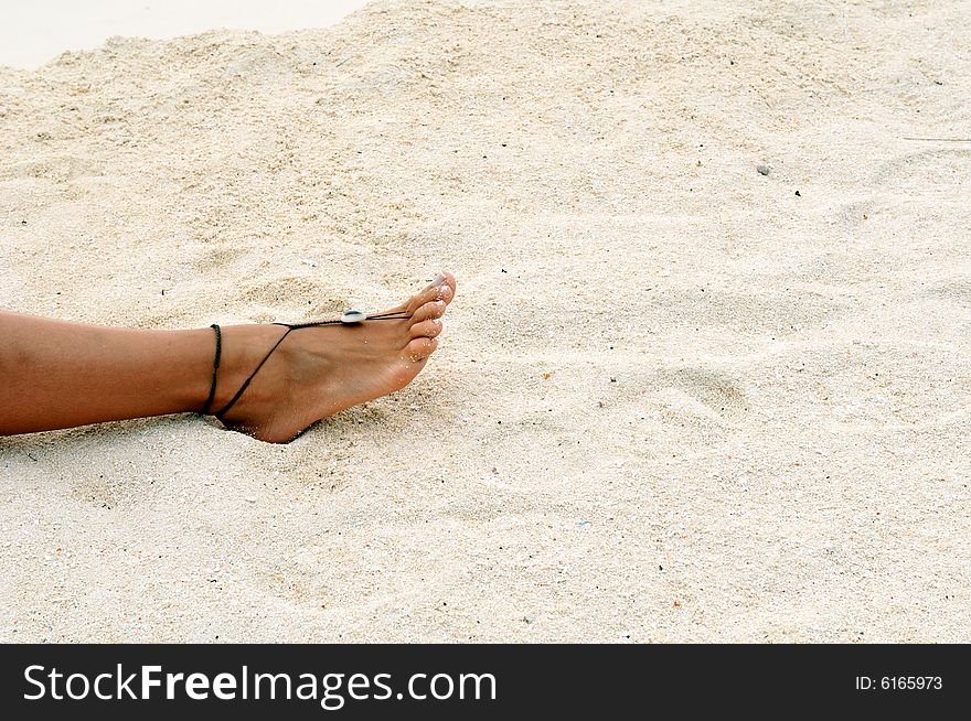 Barefoot on the sandy beach in Maldives