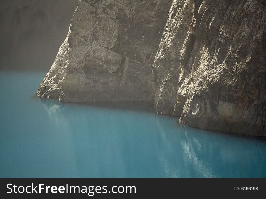 Huge vertical rock wall above the lake. Huge vertical rock wall above the lake