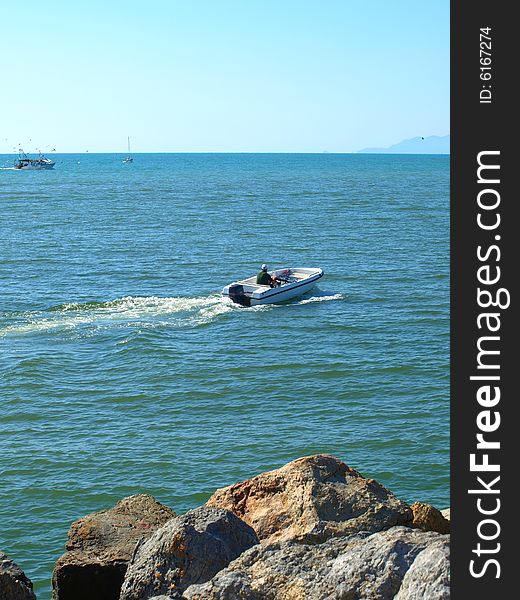 A suggestive shot of a boat that leaves the port of Viareggio. A suggestive shot of a boat that leaves the port of Viareggio