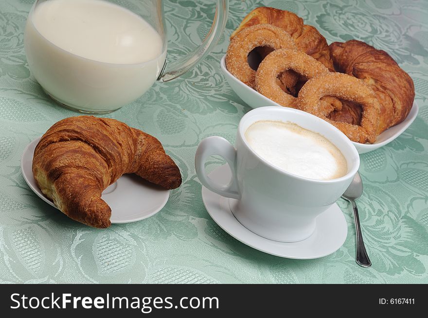 Cappuccino for breakfast, with fresh croissants and sweets