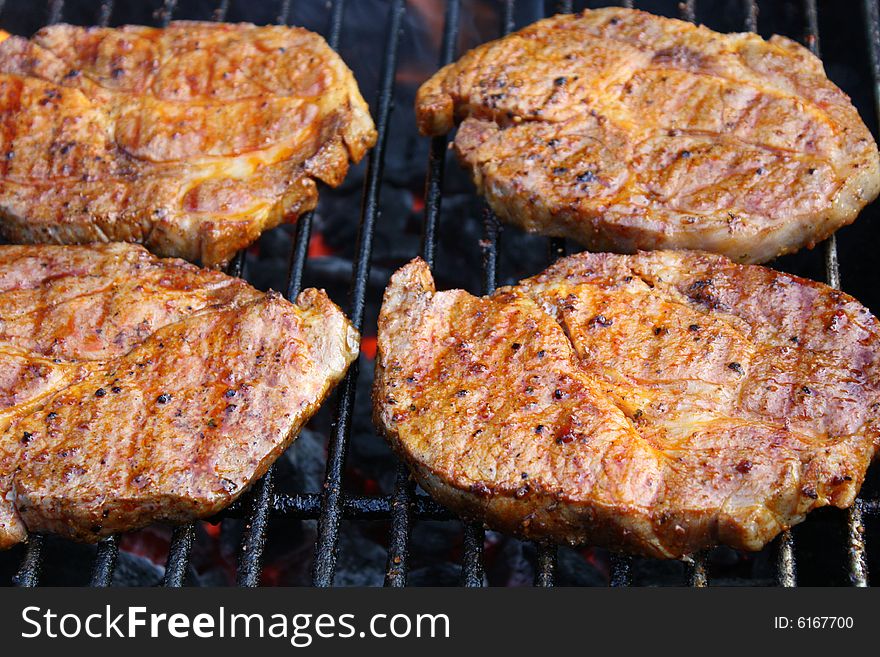 Steaks on a hot grill. Steaks on a hot grill