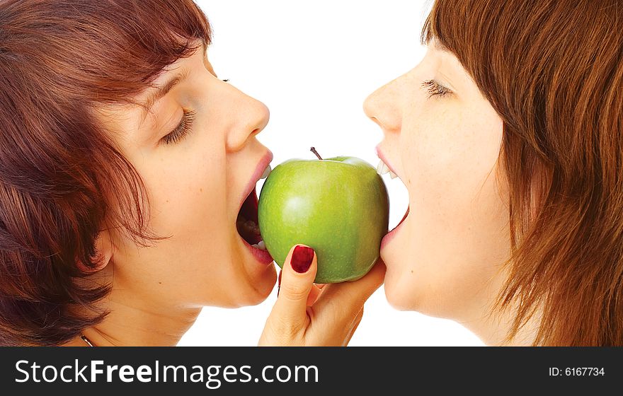 Happy young girls with apple over white