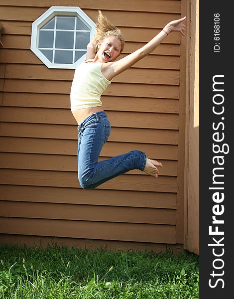 Photo of a 12 year old beautiful girl happy and jumping up in the air. Photo of a 12 year old beautiful girl happy and jumping up in the air.