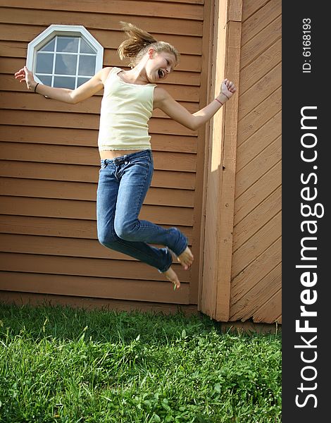 Photo of a 12 year old beautiful girl getting ready to jump. Photo of a 12 year old beautiful girl getting ready to jump