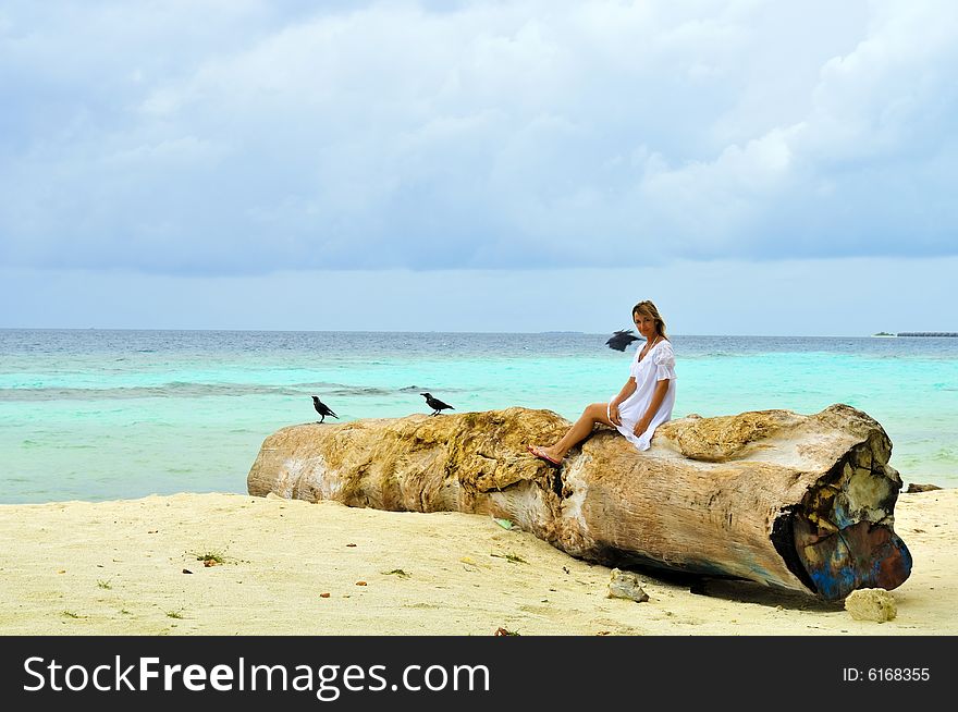 Woman sitting on a log