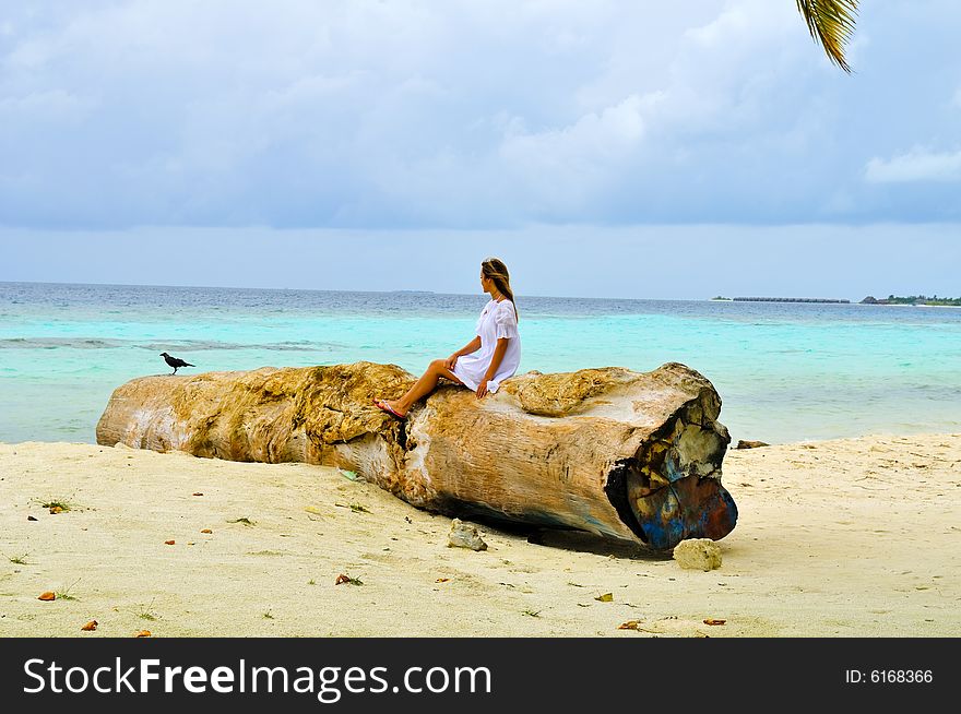 Woman sitting on a log