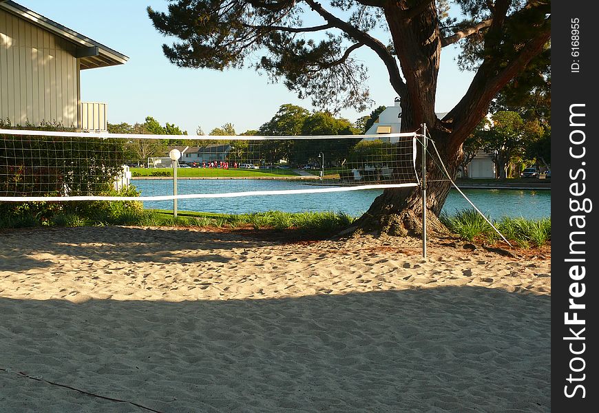 Beach volleyball court by the lake placed between the apartment buildings for the use of the residents.
Lagoon in the background and a soccer team practicing