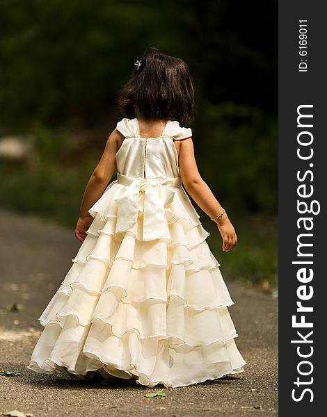 Shot of a two year old in a long white princess dress. Shot of a two year old in a long white princess dress.