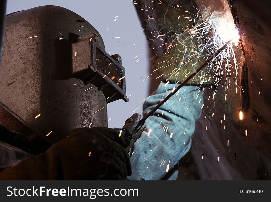A arc welder busy at work. A arc welder busy at work