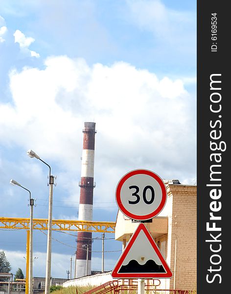 Industrial tube and road sign 30 km