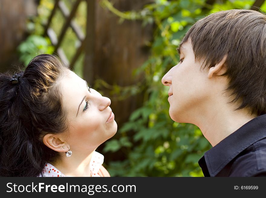Outdoor portrait of young happy attractive flirting couple