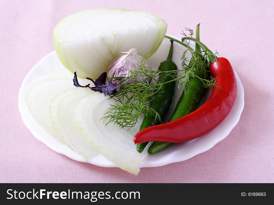 Fresh vegetable on a plate on a white background. Fresh vegetable on a plate on a white background