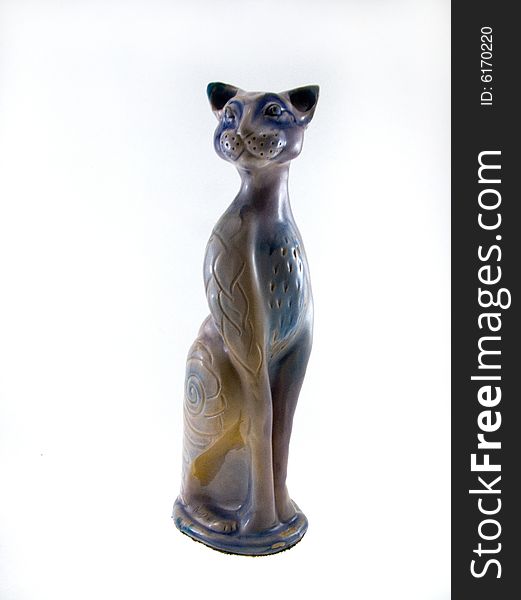 The cat sits. Ceramics. A white background.