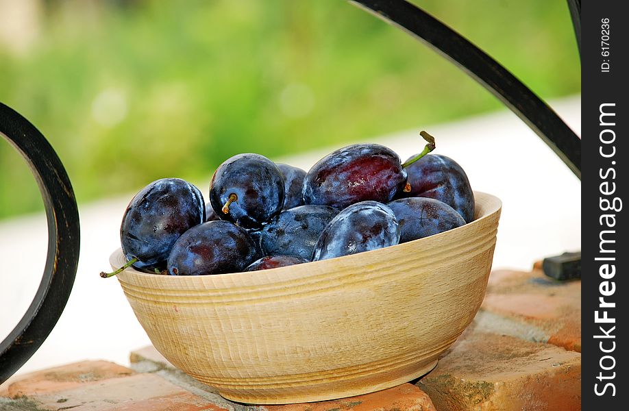 Plums wooden bowl