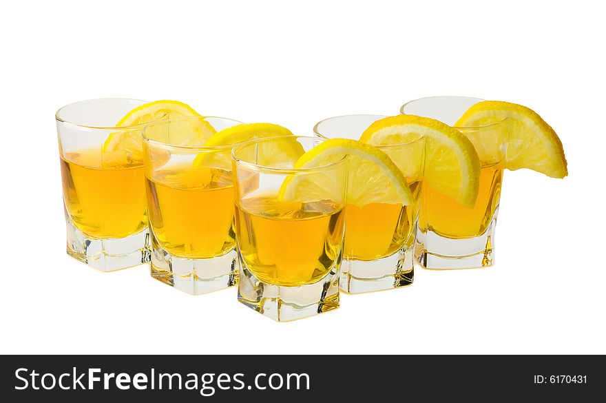 Drink and slices of a fresh lemon isolated on white background. Drink and slices of a fresh lemon isolated on white background.