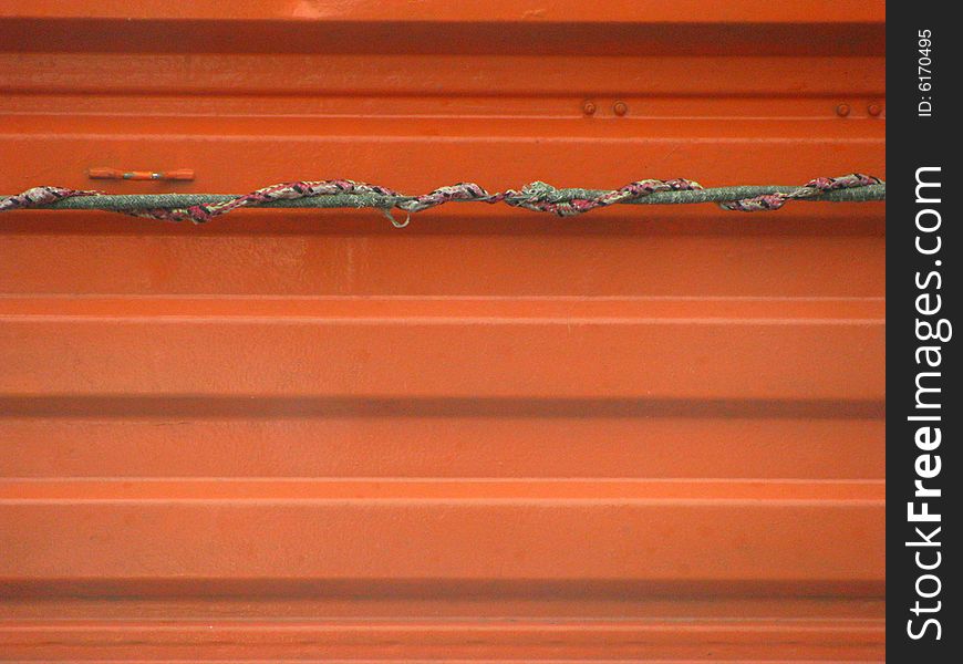 Orange metal texture with rope. Orange metal texture with rope