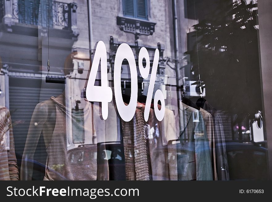 Forty percent discount sign on clothes shop's window. Forty percent discount sign on clothes shop's window