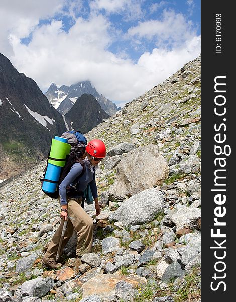 Gril backpacker traveling on talus in mountains