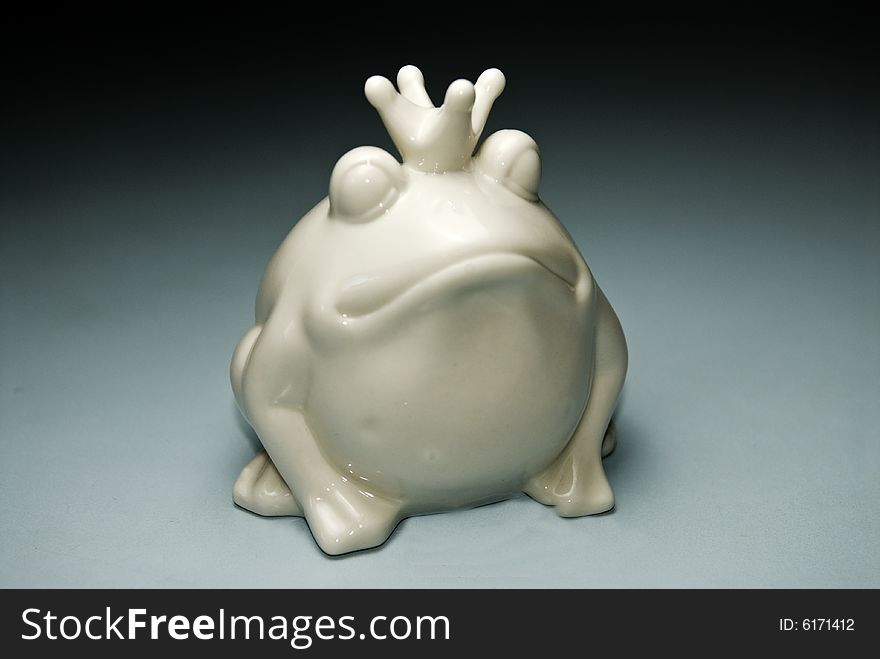 A white China frog money box on a grey background