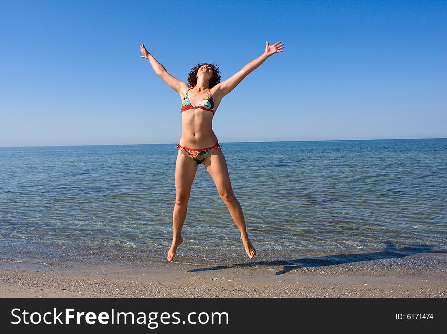 Girl jumping at sand sea beach. Girl jumping at sand sea beach