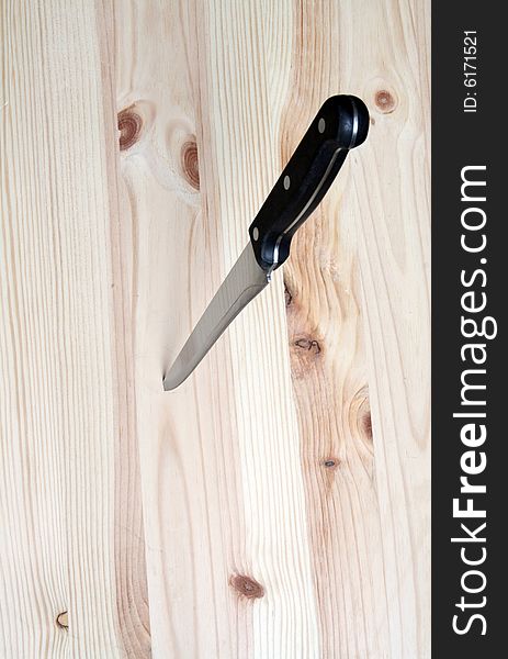 Knife in wooden plate